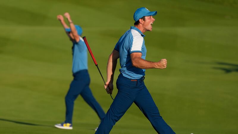 Europe's Viktor Hovland reacts and celebrates after his birdie putt earned Europe a tie in his...