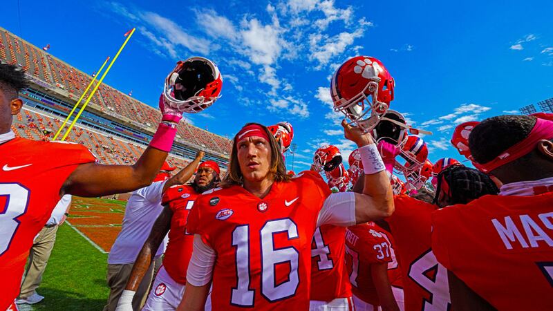 Clemson players hold up their helmets during before their game against Syracuse on October 24,...