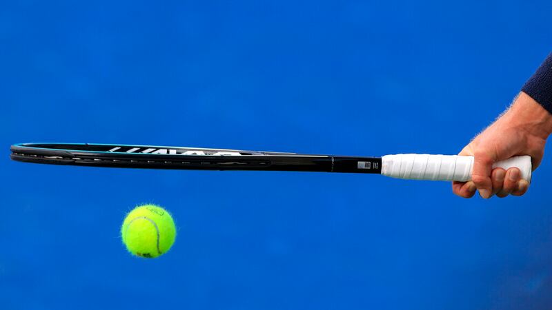 Andrey Rublev, of Russia, bounces a tennis ball under his racquet as he prepares to serve to...