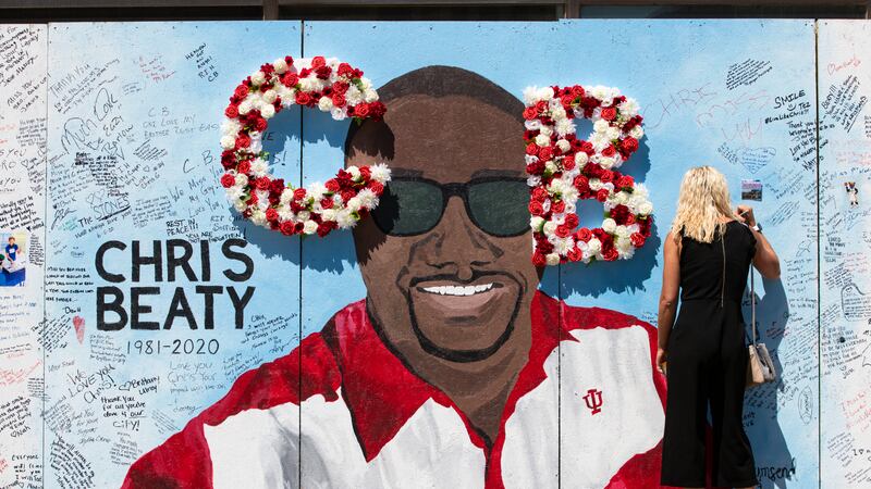 FILE - In this June 12, 2020 file photo, a mourner signs a tribute wall during a memorial...
