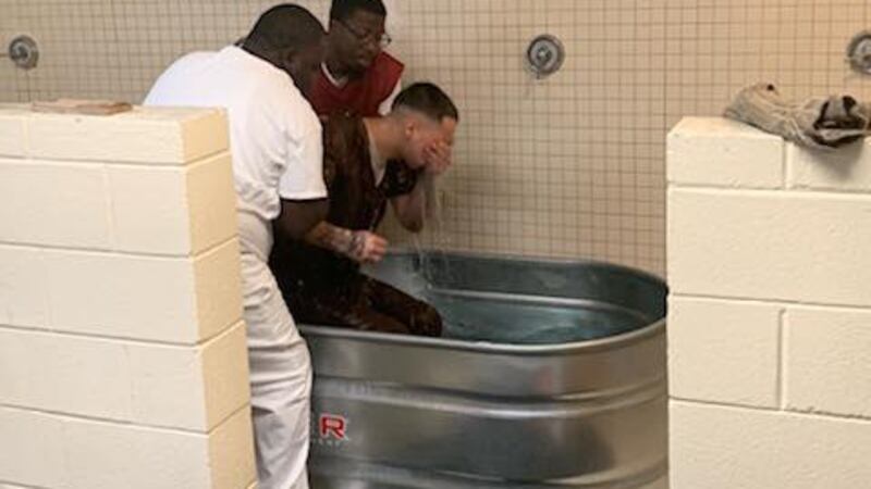 Officials say 18 inmates were baptized Sunday.