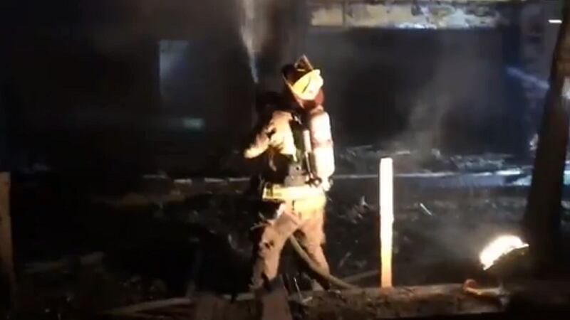 An Horry County firefighter helps to put out a fire that broke out Friday night at the Ocean...