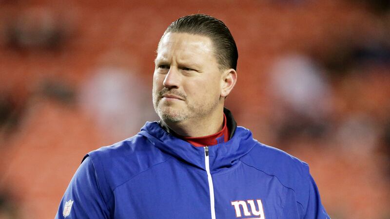 FILE - New York Giants coach Ben McAdoo stands on the field before the team's NFL football...