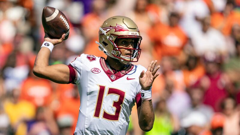 Florida State quarterback Jordan Travis throws a pass during the first half of an NCAA college...