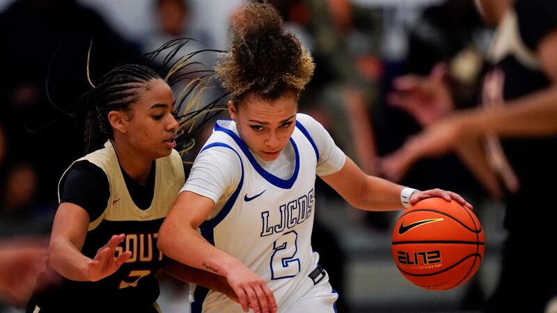 La Jolla Country Day high school point guard Jada Williams, center, drives to the basket...