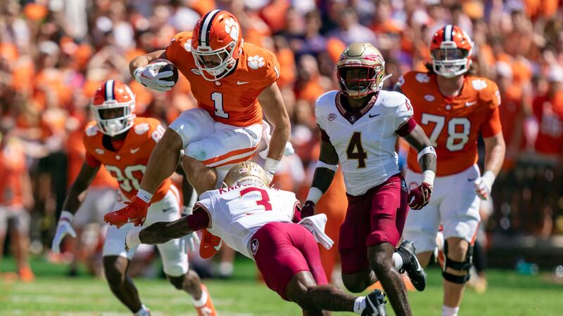 Clemson running back Will Shipley (1) jumps over Florida State defensive back Kevin Knowles II...