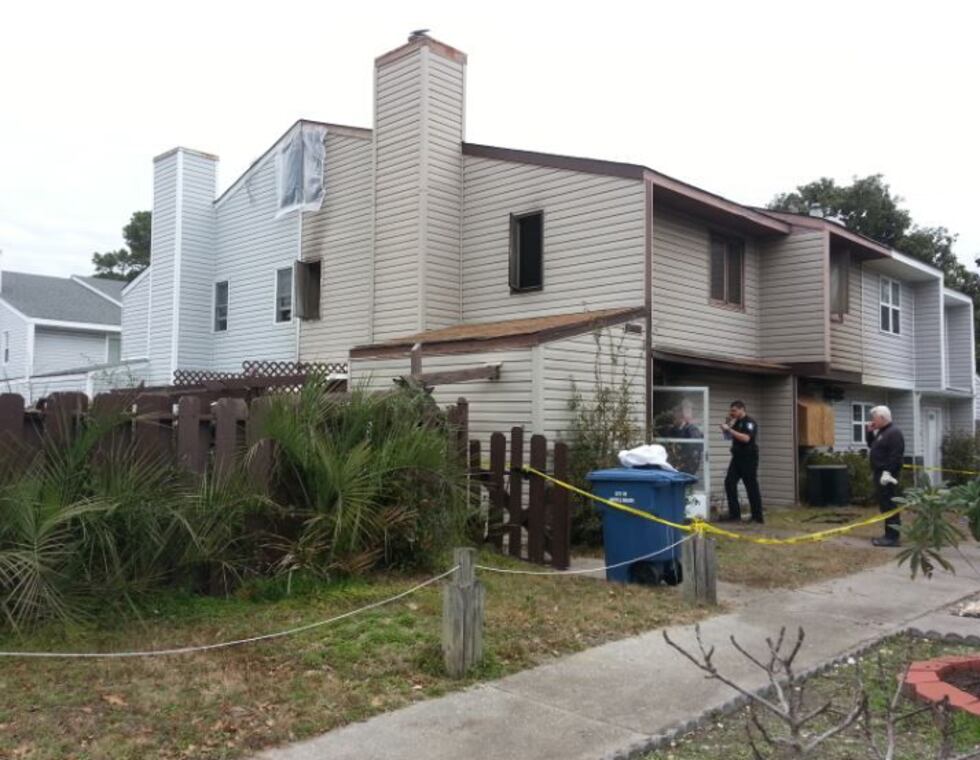 Fire investigators examine the area Friday.