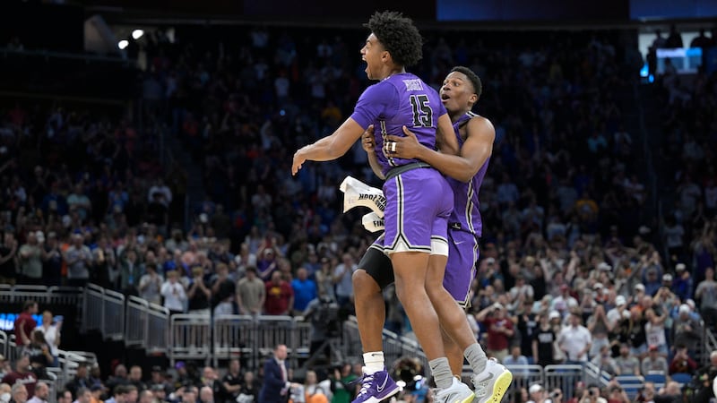 Furman forward Tyrese Hughey (15) and forward Alex Williams, right, celebrate their win...