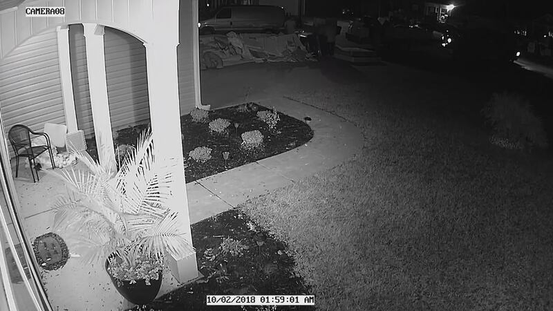 Residents' surveillance camera captures two people taking goods from outside home on Oct. 2,...
