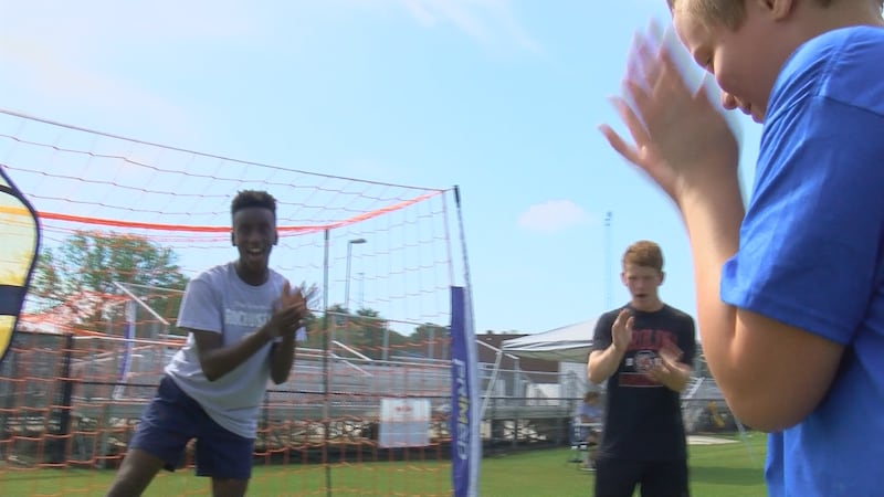 Lashaun Scott and classmates cheer on a Special Olympian to score a goal.
