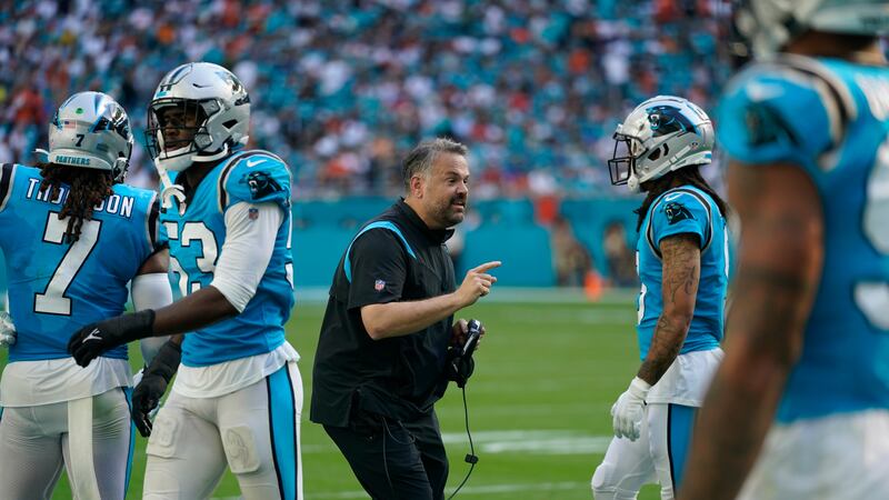 Carolina Panthers head coach Matt Rhule, center, talks to his players during the first half of...